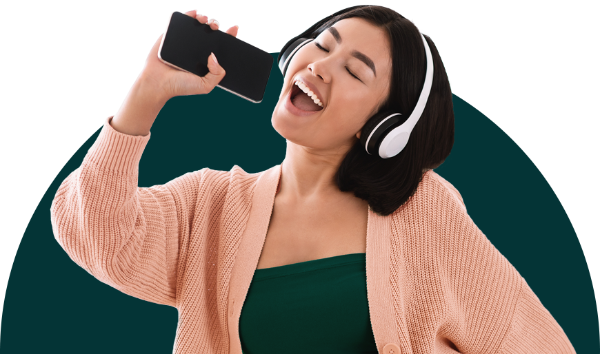 woman singing into cellphone wearing headphones
